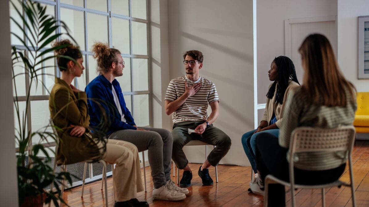 Young adults participating in group therapy.